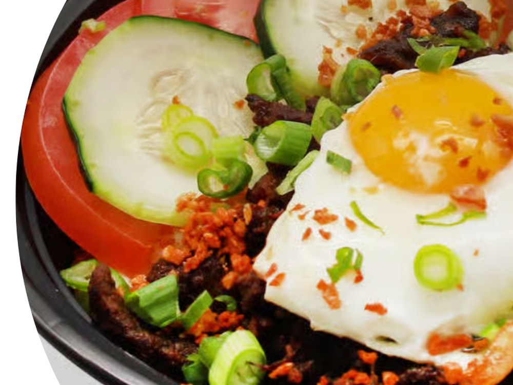 Beef Tapa Rice Bowl — marinated beef with garlic rice, sunny-side egg, tomato and cucumber