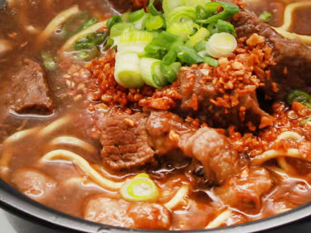 Pares Mami — beef pares served over egg noodles in broth with scallions