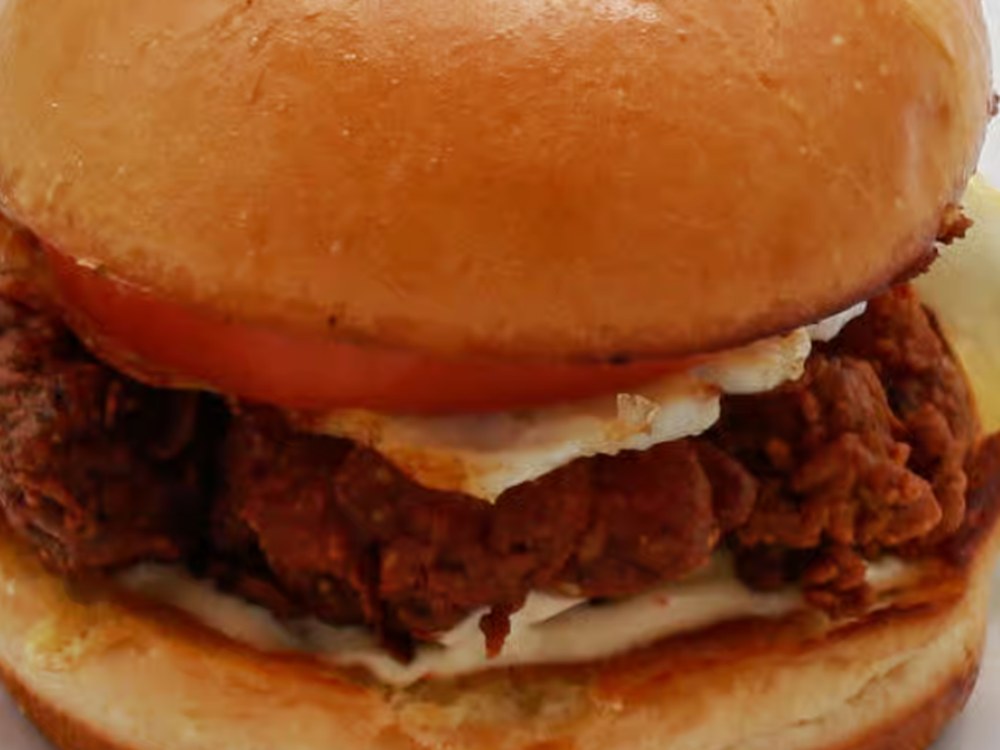 Pork Belly Sandwich — crispy pork belly, egg, tomato and cucumber in a toasted bun