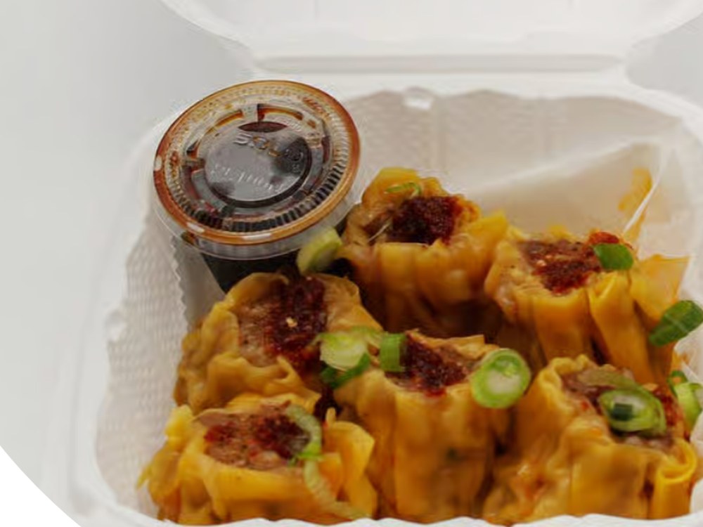 Six steamed pork siomai with chili garlic and toyomansi dipping sauce